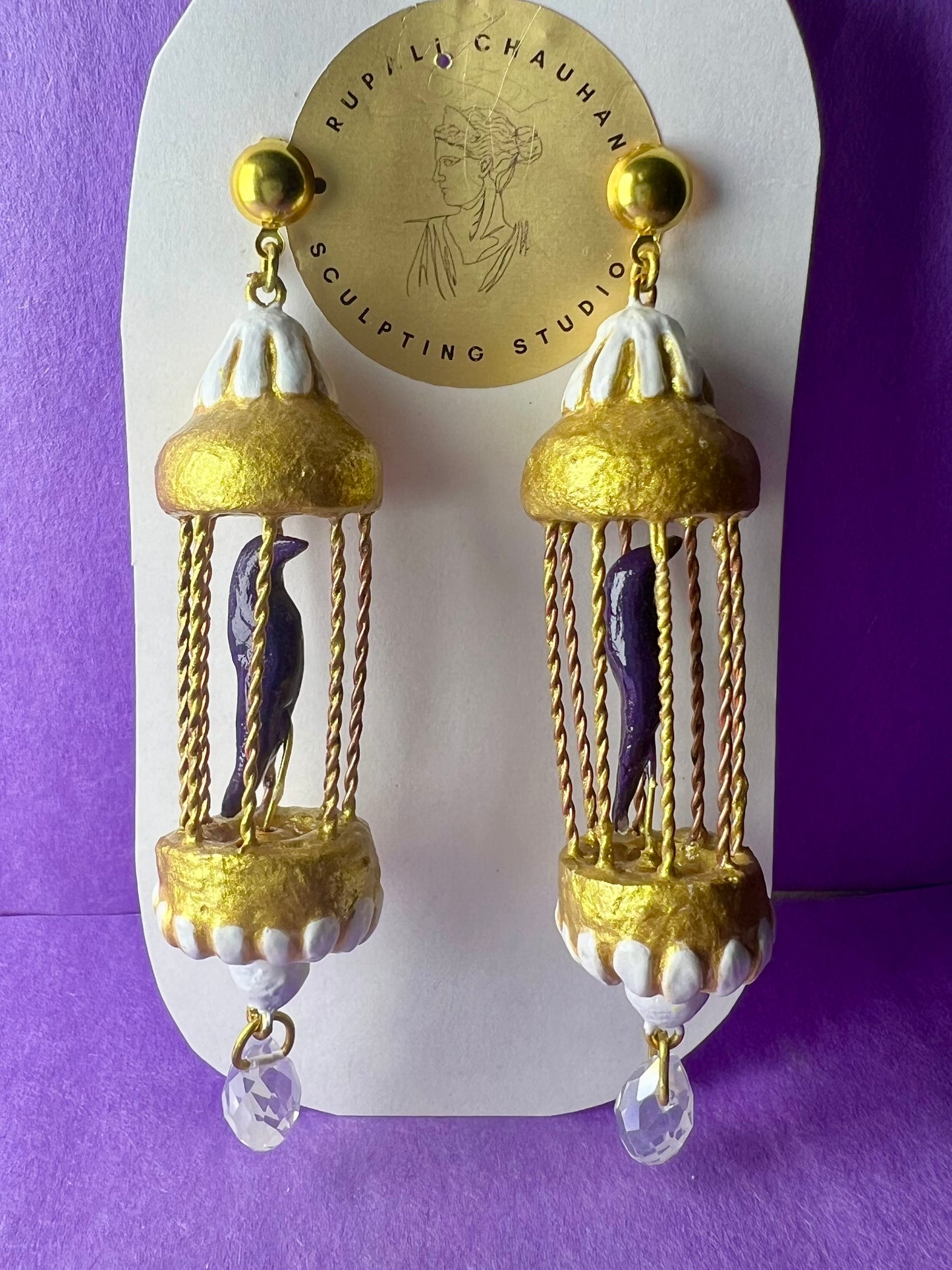 Purple bird in golden cage dangler