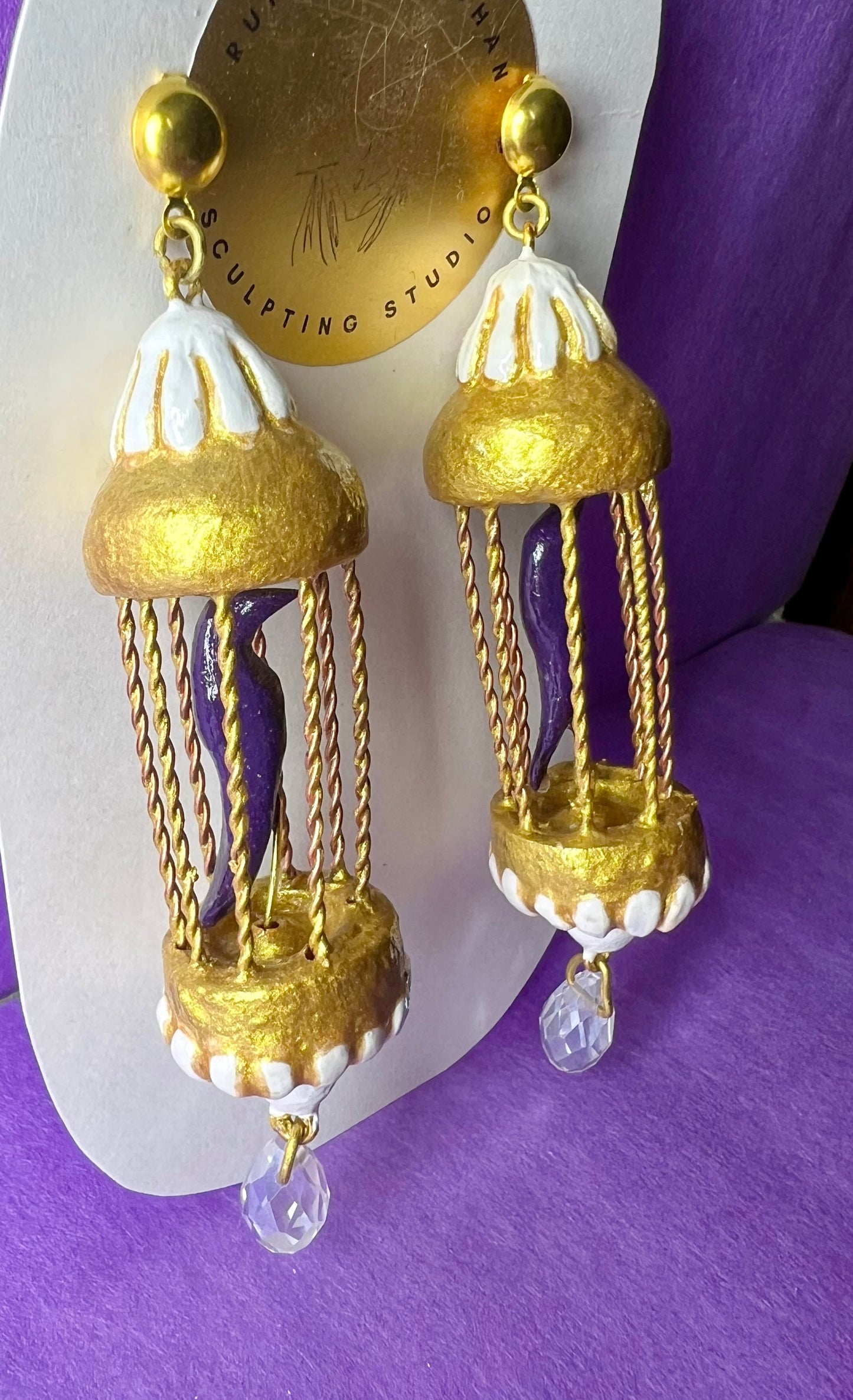 Purple bird in golden cage dangler