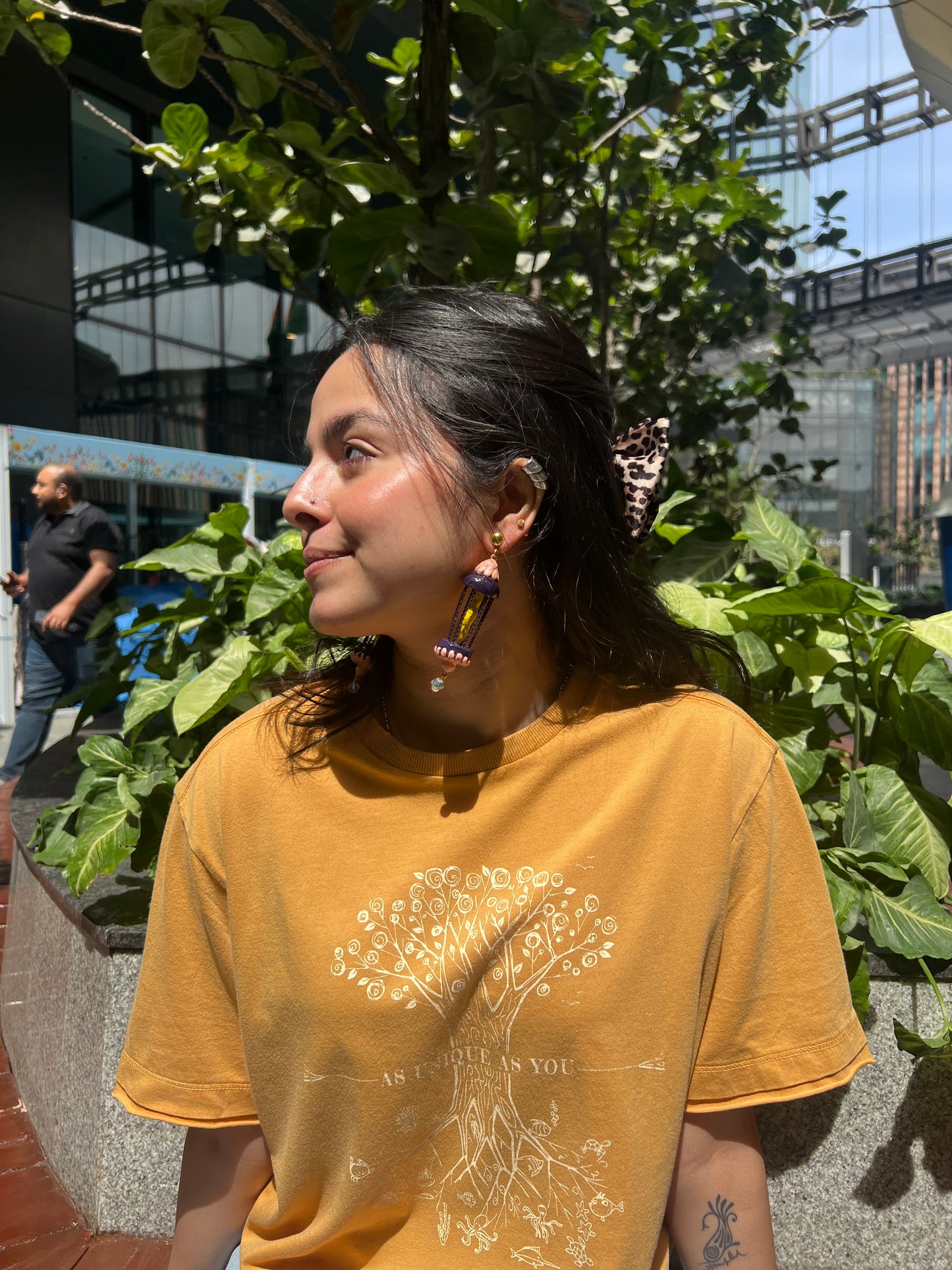 Yellow bird in a purple cage dangler